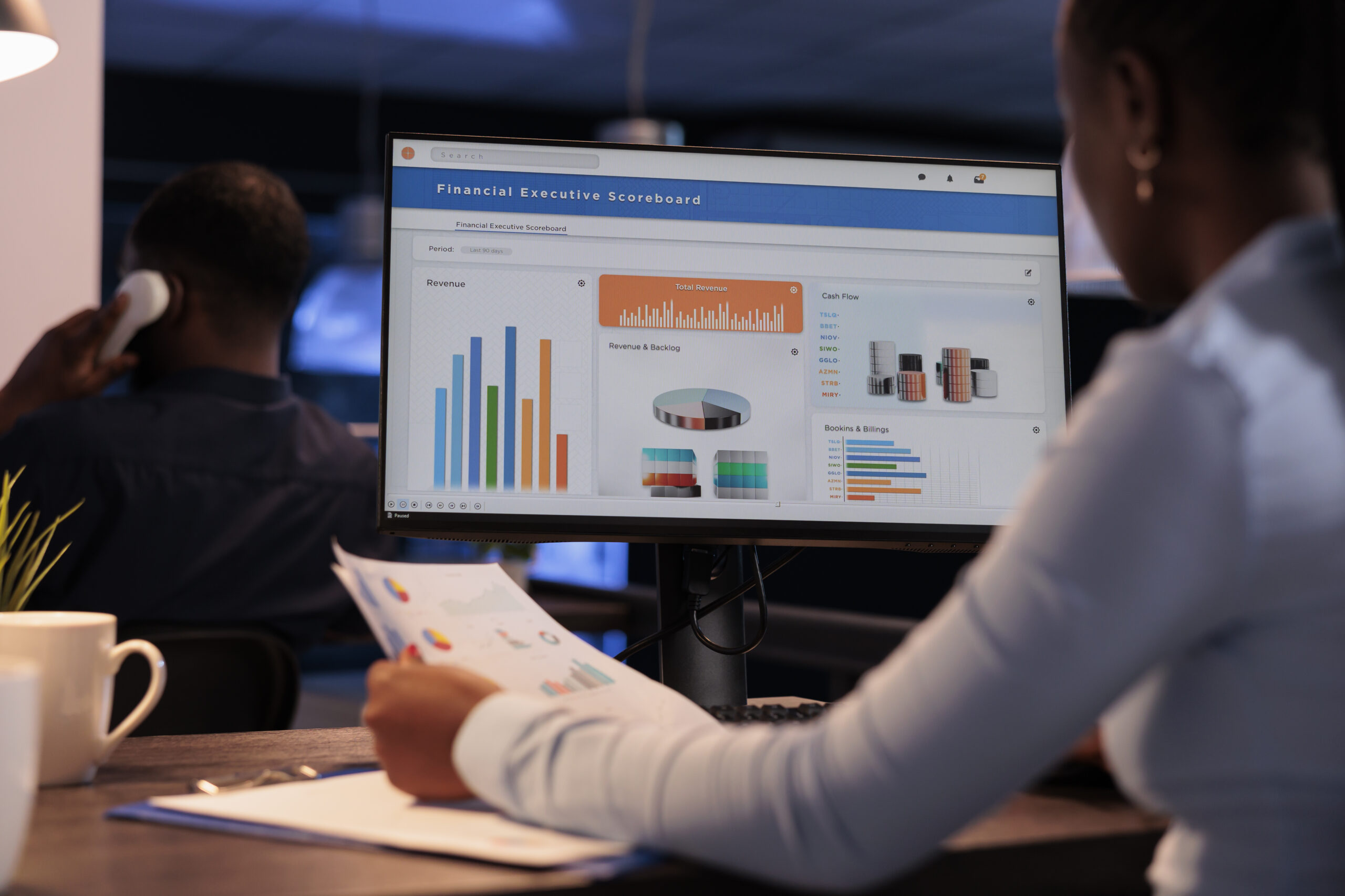 Office employee analyzing business charts on computer